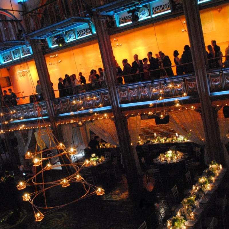 interior venue event space with low lighting and people talking