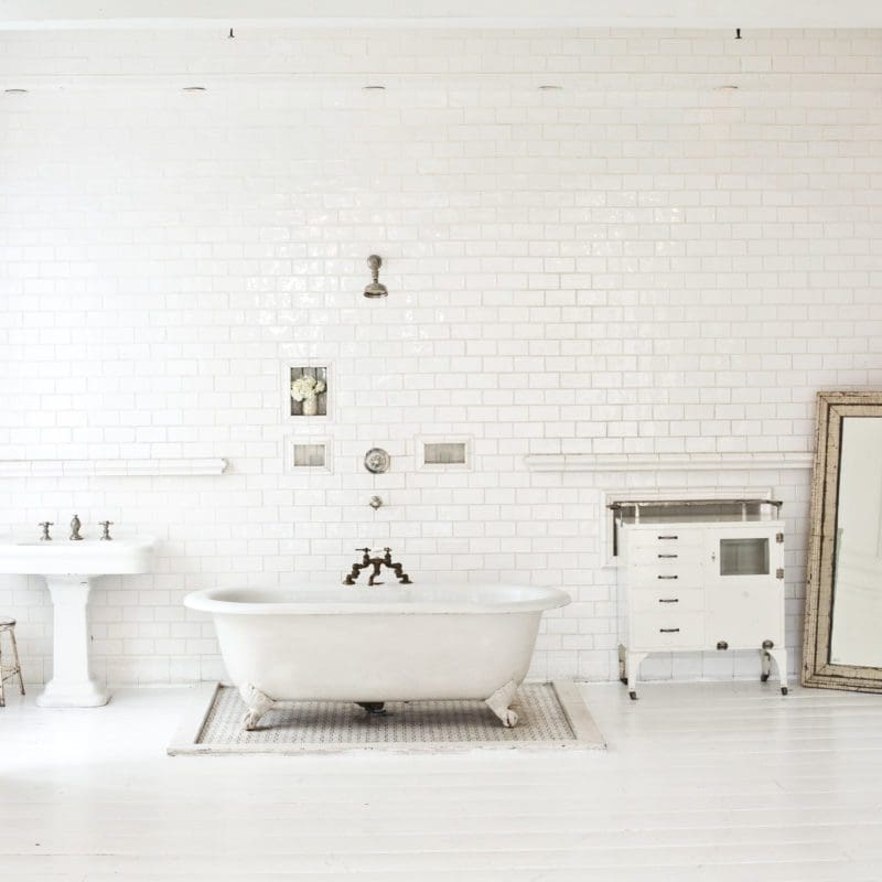 large white bathroom with tub and sink