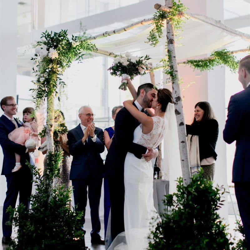 bride and groom embracing at altar