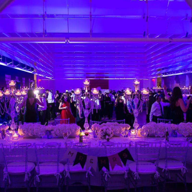 interior venue event space with purple lighting and dining area