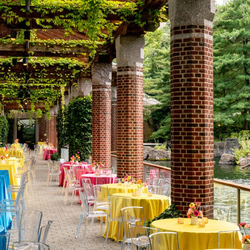 Colorful tables set outdoors at for a corporate event at Central Park Zoo.