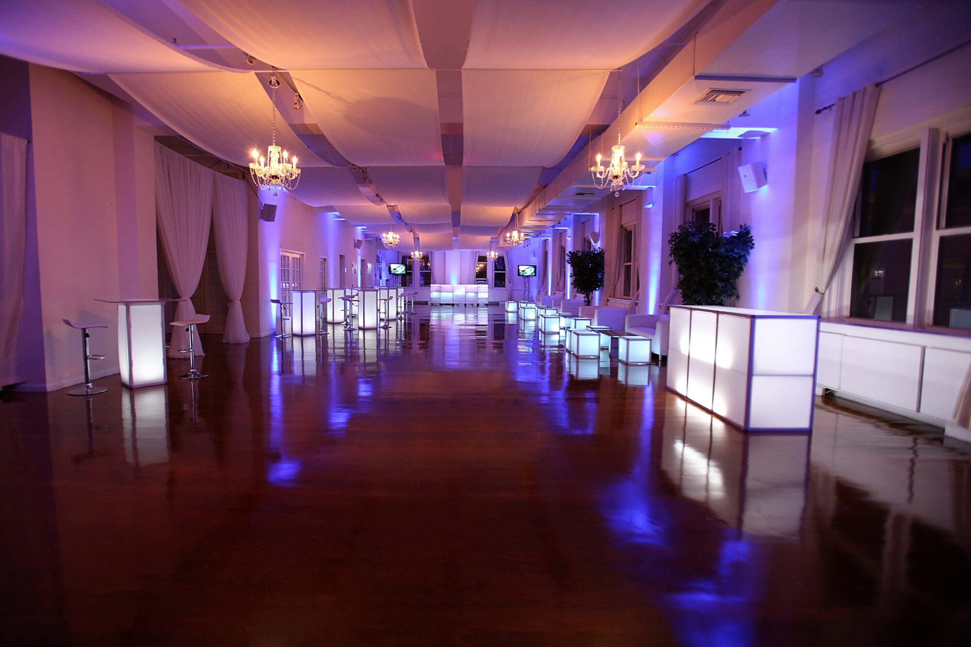 large interior venue with bars and tables
