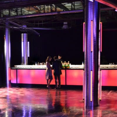 two people standing at the bar