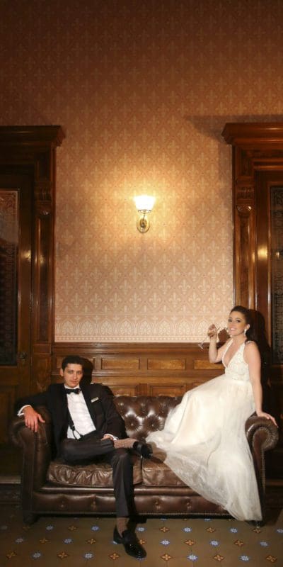 bride and groom posing on a couch