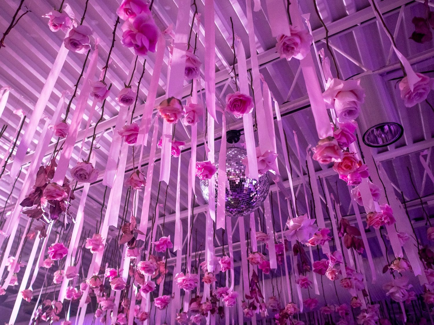 floral decorations and a disco ball hanging from a ceiling