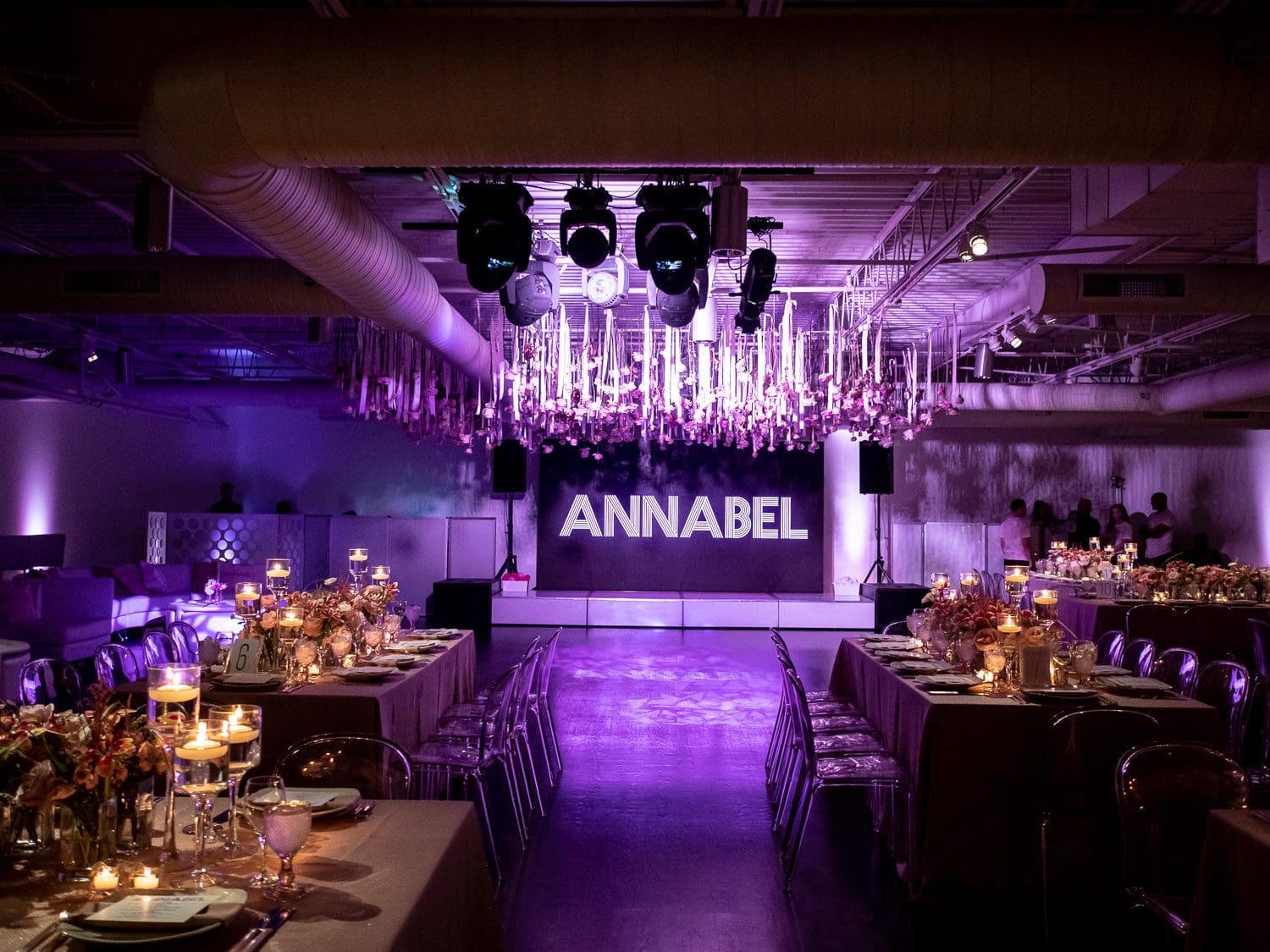 large interior venue with fine dining settings and a large sign that reads Annabel