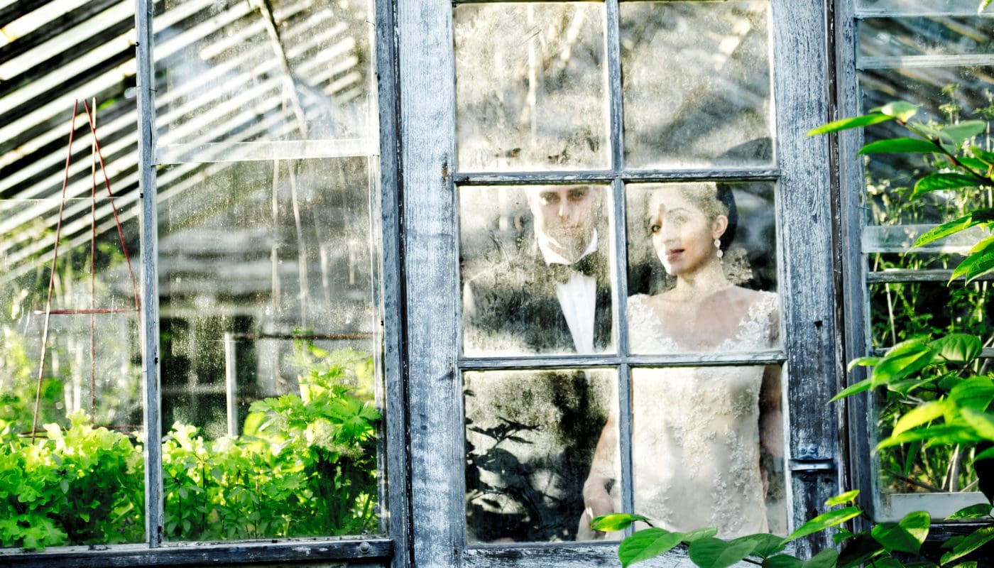 bride and groom looking out a window