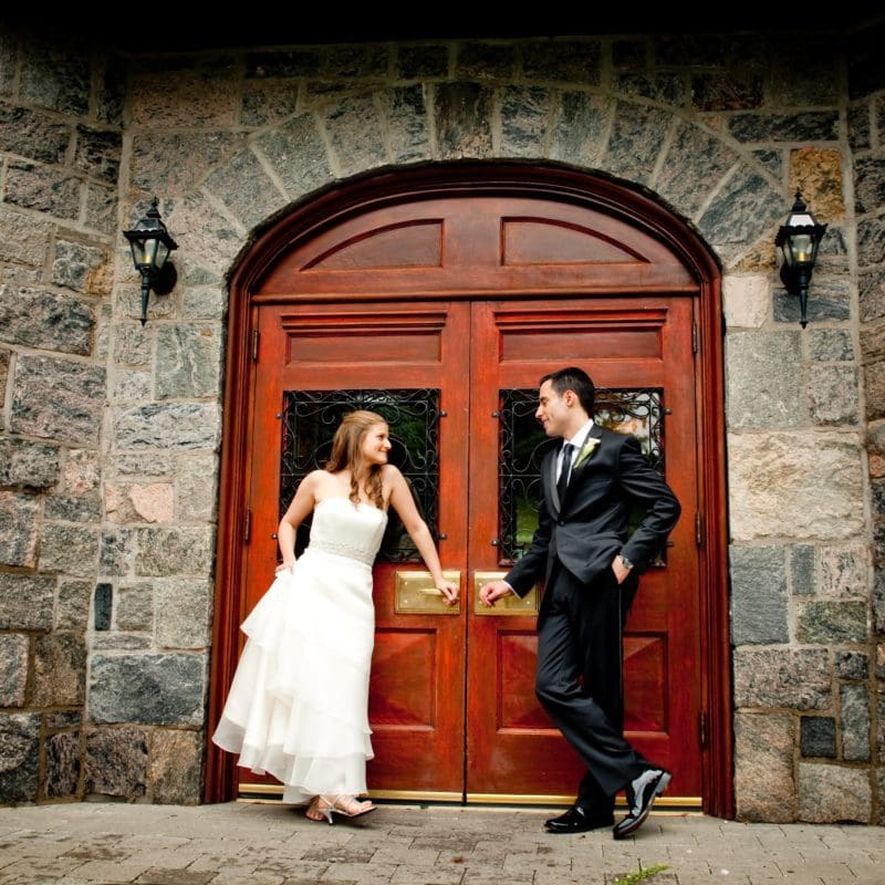 bride and groom posing outside tappan hill mansion