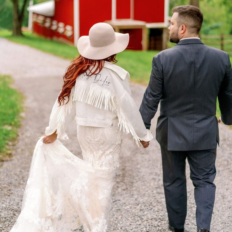 Married couple walking down gravel path