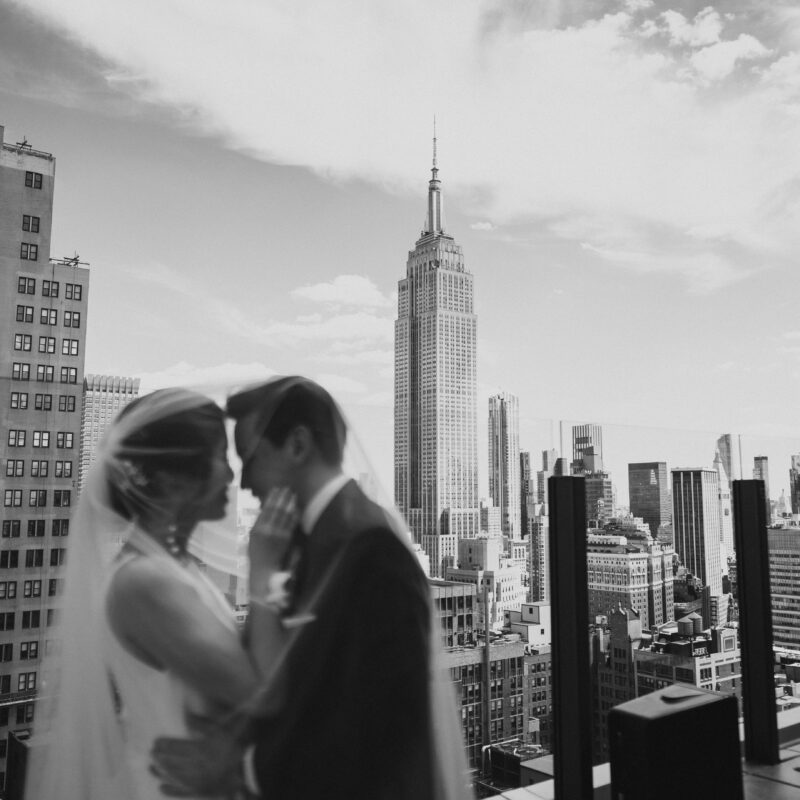 Bride and groom in front of Empire State Building from The Skylark rooftop