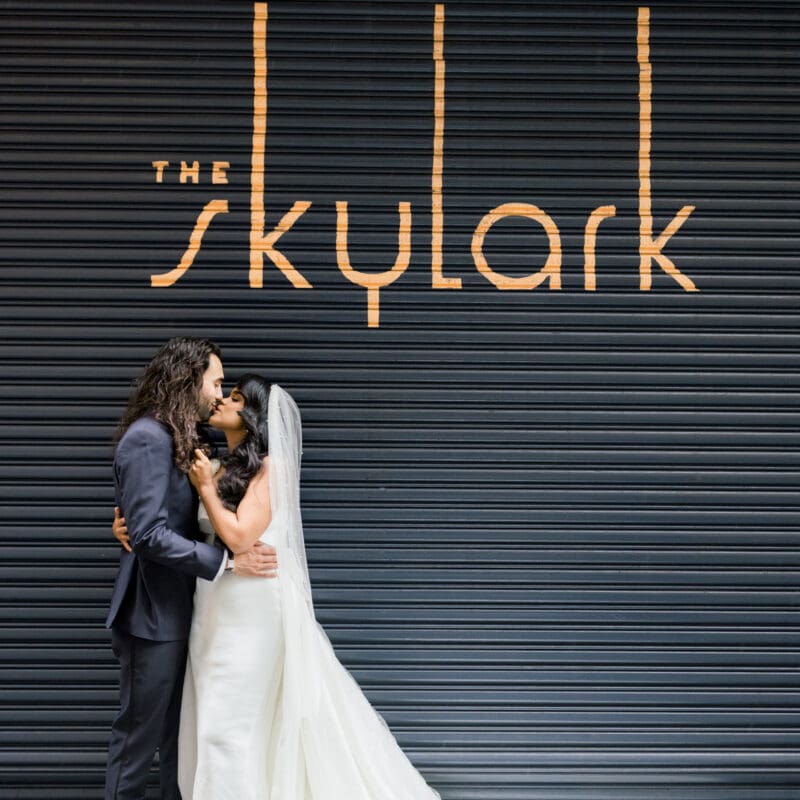 Wedding couple in front of exterior Skylark sign