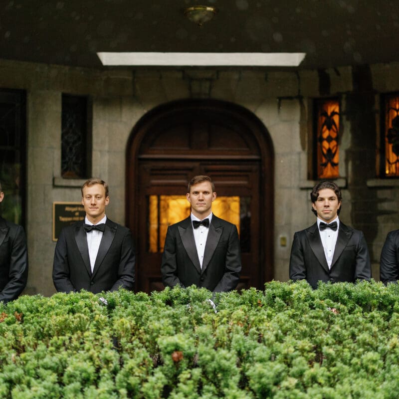 groomsmen in front of mansion