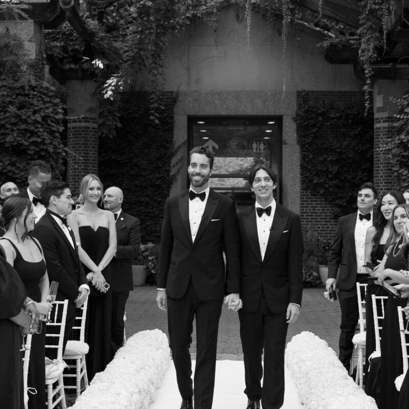 Couple walking down the aisle outdoors in Central Park Zoo, New York City