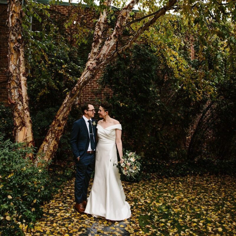 bride and groom embracing outside