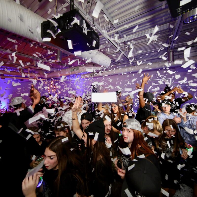 people throwing confetti into the air