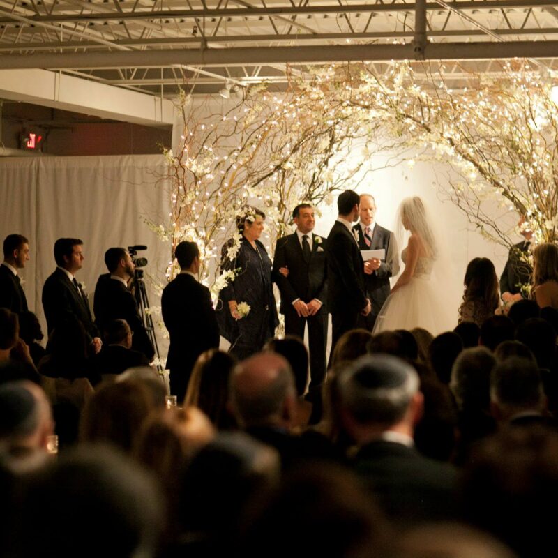 bride and groom at alter with guests watching