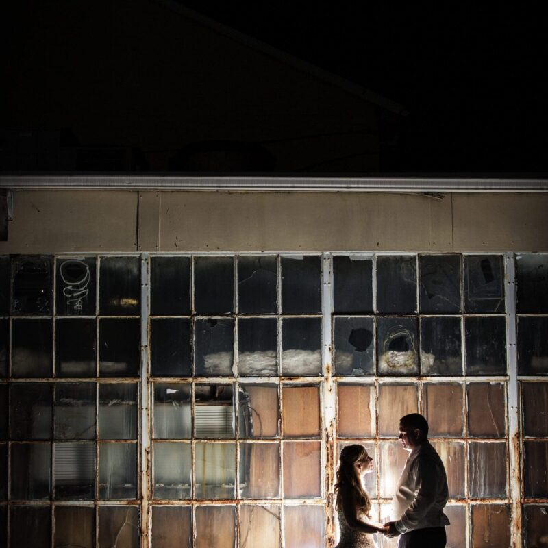 bride and groom embracing outside