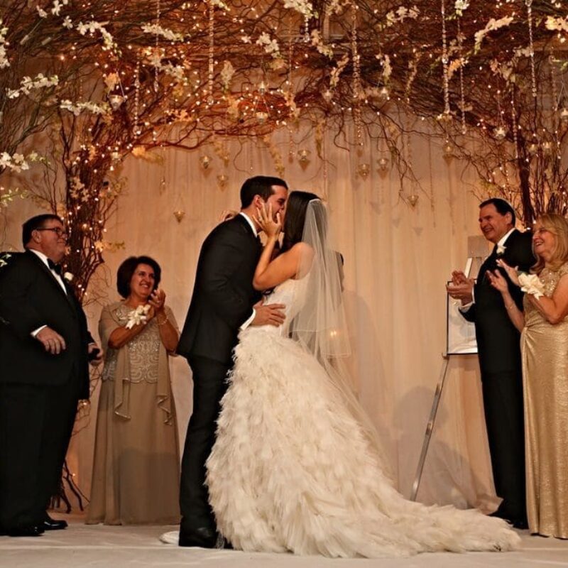 bride and groom embracing at alter