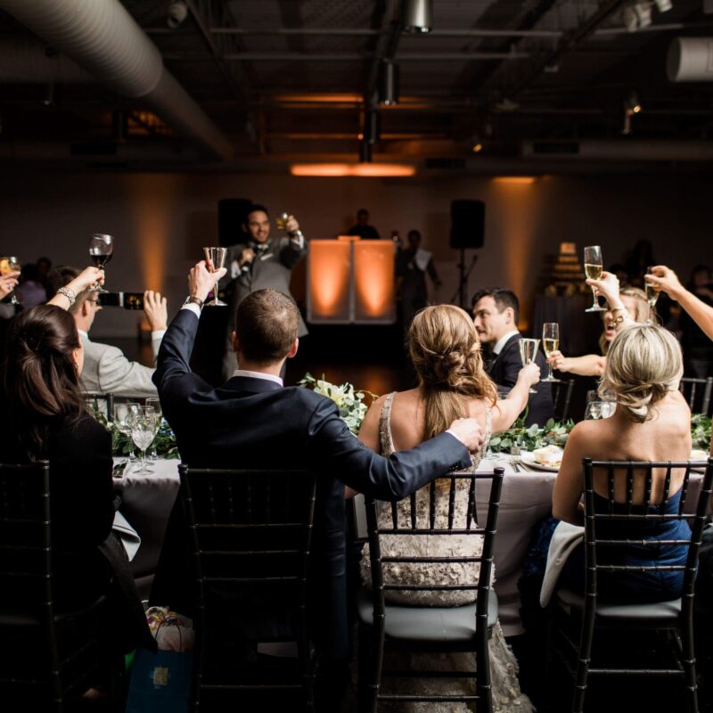 guests cheer-sing at table