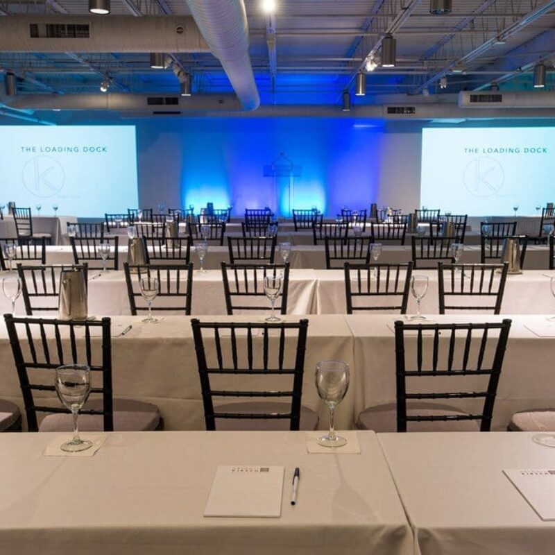 tables with pens and papers in an event space