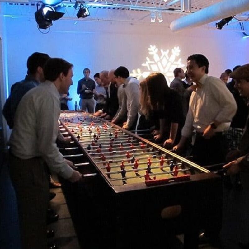guests playing large fooseball game