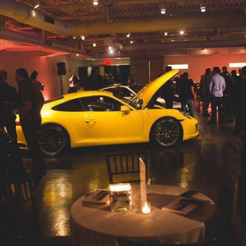 interior venue area with guests and a car