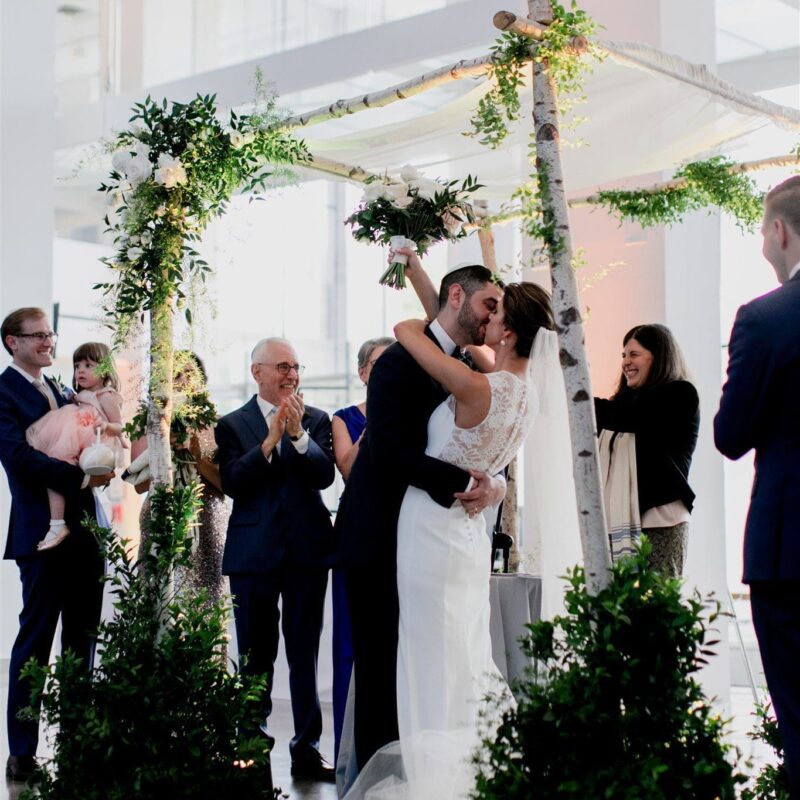 bride and groom embracing at altar