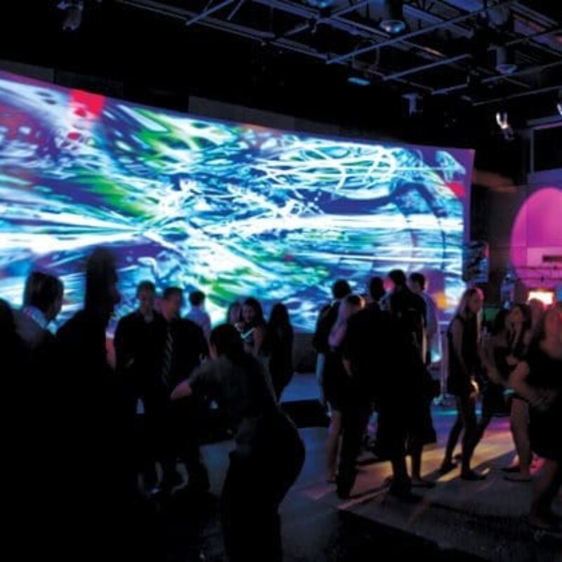 Stepping Stones Museum interior shot with a crowd and a large screen