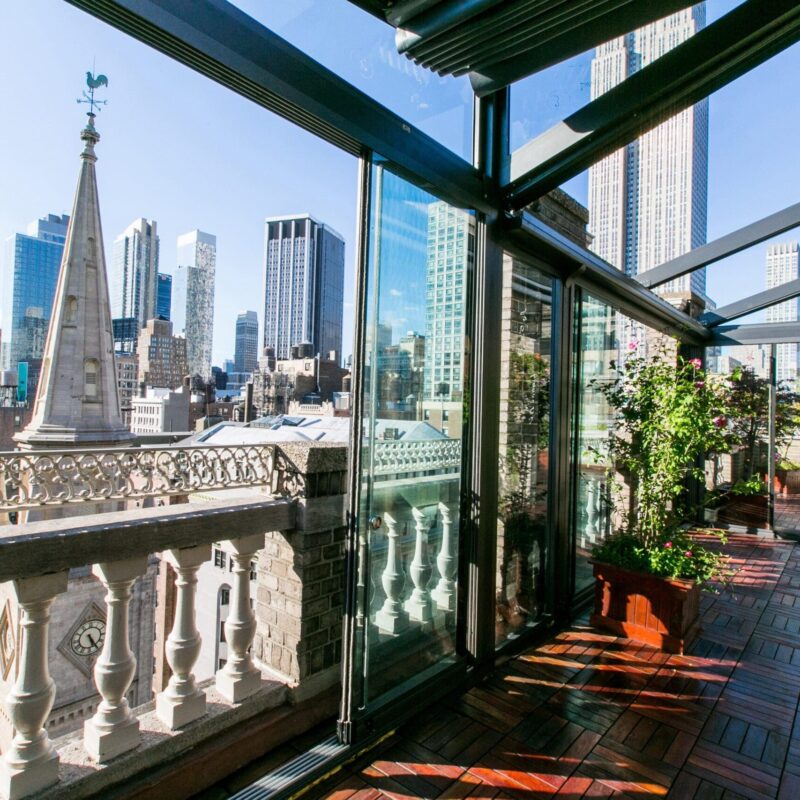 interior venue with glass walls looking out to the new york city skyline