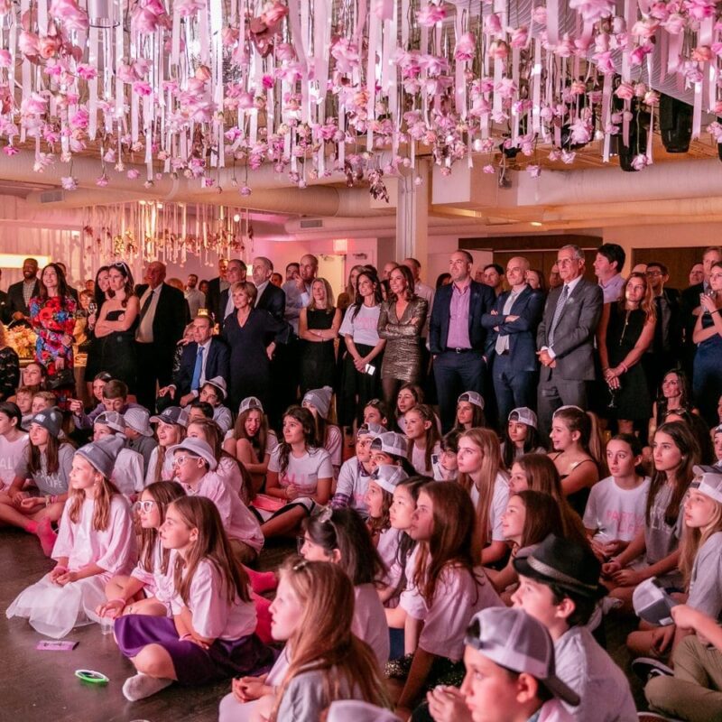 mitzvah guests watching the program
