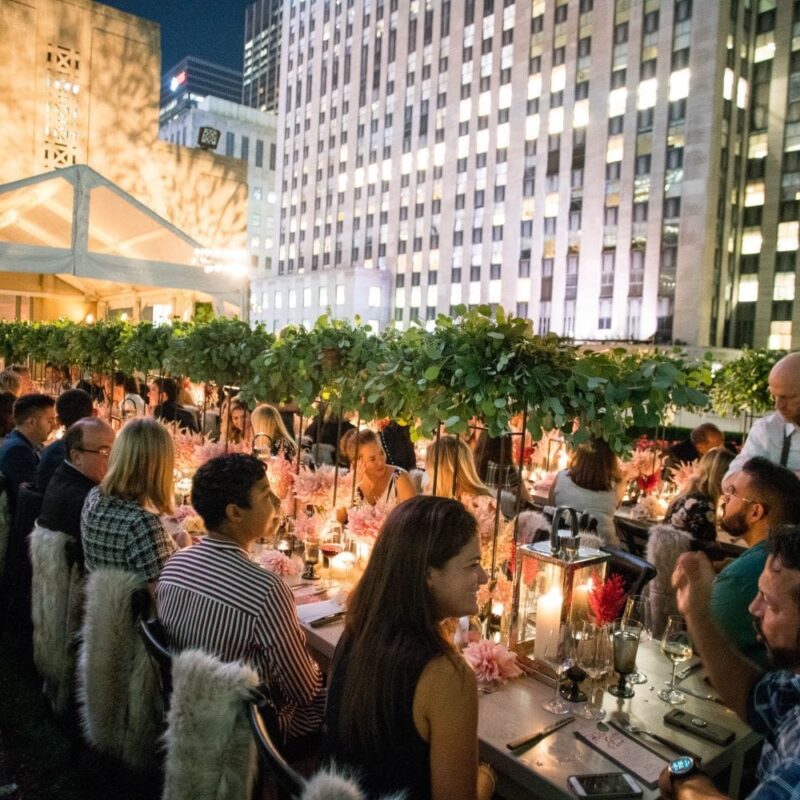 Guest at seated dinner set up at 620 Loft & Garden Rooftop