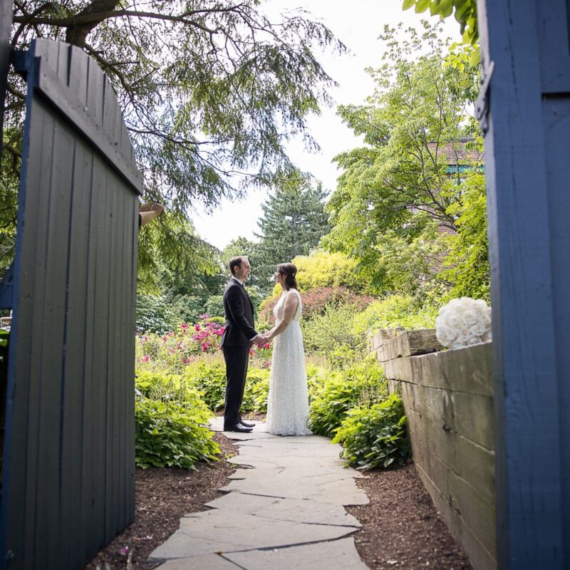 Bride and groom holding hands in Hudson Garden at Tappan Hill Mansion