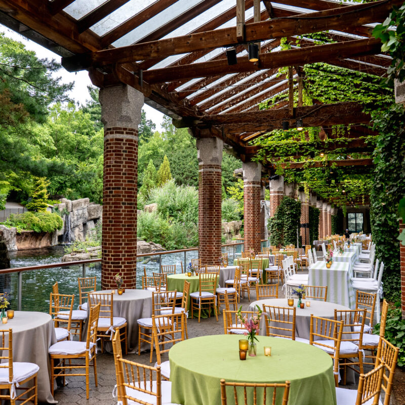 Guest tables and chairs set for an event at the Central Park Zoo in Manhattan